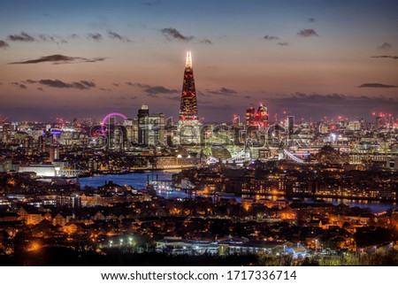 Panoramic view to the illuminated urban skyline of London, UK, featuring all the major tourist attractions just after sunset time