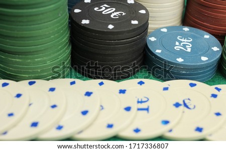 casino chips on green field background, gambling, selective focus