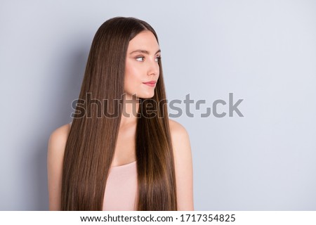 Profile photo of pretty charming lady not smiling presenting ideal neat long hairstyle look empty space wear beige singlet isolated grey color background