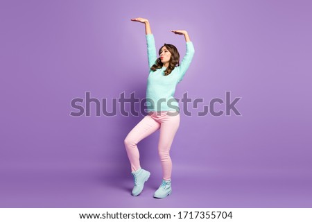 Full body profile photo of chilling pretty lady raise hands dancing youth modern popular moves wear casual fluffy jumper pink pastel pants shoes isolated purple color background