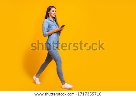 Full size profile side photo lovely charming pretty girl go walk copyspace use smartphone texting her friends meeting wear good look shirt footwear isolated shine bright color background