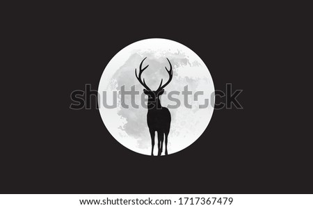 Silhouette of deer in front of the moon