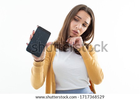 Beautiful girl is upset about the broken phone