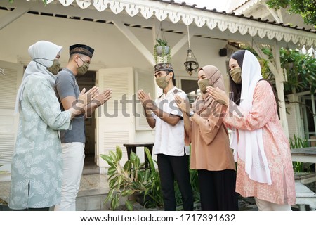 muslim social distancing. eid mubarak during pandemic. family meeting and greeting without physical touching Royalty-Free Stock Photo #1717391632