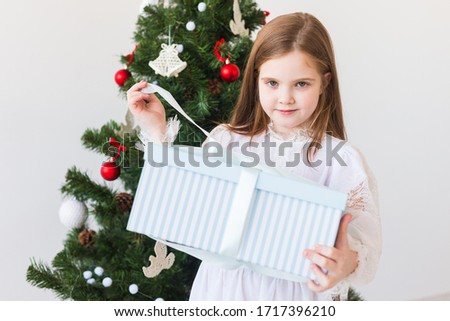 Holidays, presents, christmas, x-mas concept - happy child girl opens gift box. gift box.