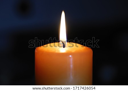 orange burning candle at night