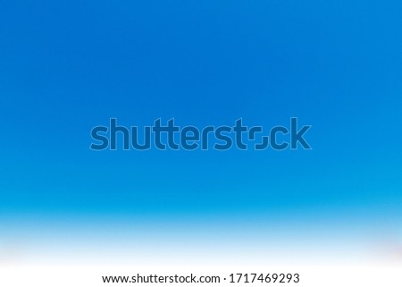 Abstract nature background of beautiful clear blue sky with wispy white clouds in summer sunlight & sun rays for wallpaper & backdrop, gradient seamless pattern & texture details, copy free space Royalty-Free Stock Photo #1717469293