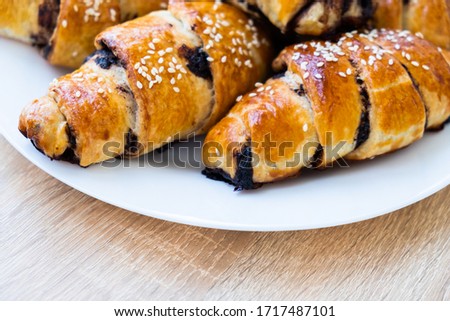 
croissants with chocolate on a white plate