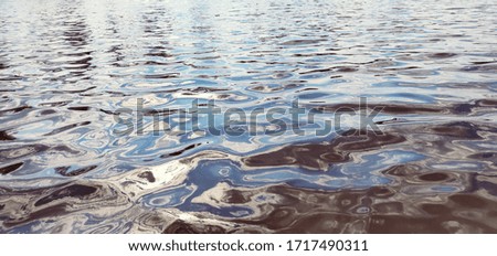 Water surface. Picturesque texture of river water. Macro image. Ripple on the surface of river.