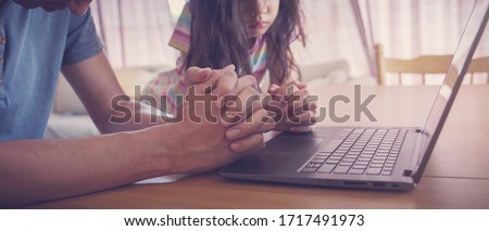 praying hands, family praying with laptop, and parent and kid worship online together at home, streaming online church service, social distancing, new normal concept