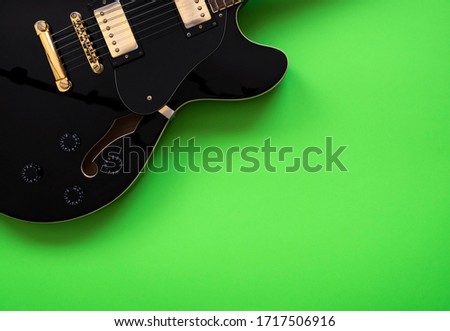 Electric guitar on a green background