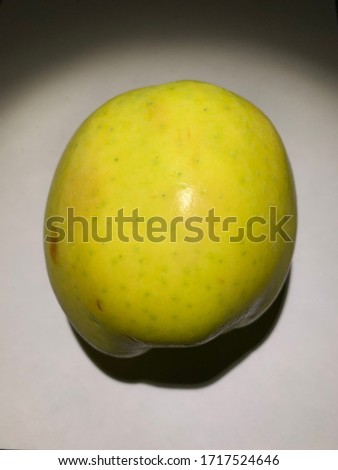 A beautiful, large,juicy, Apple is photographed on a white background.