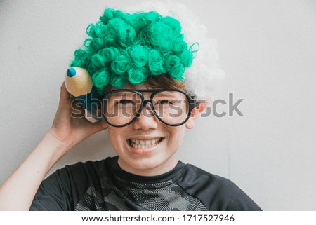 Geeky boy with a green wig.