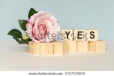 The word Yes. written in black letters on wooden blocks. Message spells Yes on white background. Business, motivation and education concept