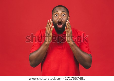 Portrait of shocked black male says wow, looks bugged eyes and rounded mouth, being amazed to see something unexpected. Terrified Afro American guy with surpised expression.  Royalty-Free Stock Photo #1717557481