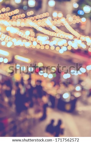 Vintage tone abstract blurred image of Street  night festival with light bokeh  for background usage.