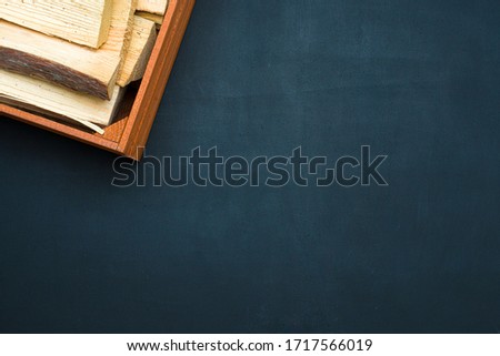 Wooden box with firewood on a black background.