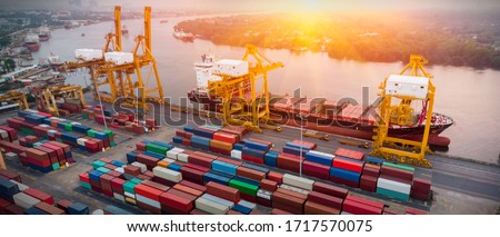 Logistics and transportation of Container Cargo ship and Cargo plane with working crane bridge in shipyard at sunrise, logistic import export and transport industry background Royalty-Free Stock Photo #1717570075