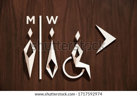 Bathroom symbol on wooden background.