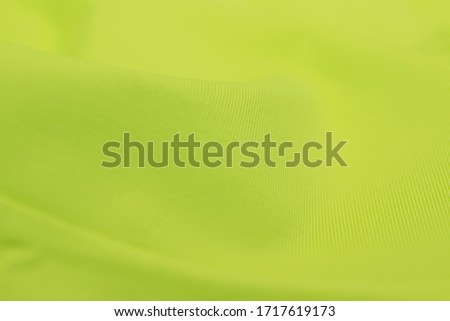 Yellow fabric clothing texture textile pattern blur background with space for text.