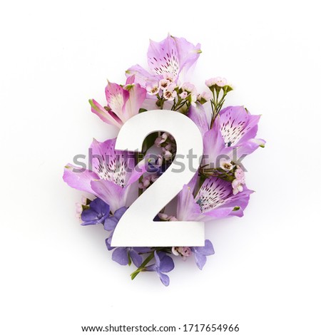 Creative layout with colourful flowers and number two. Flat lay. Top view. Royalty-Free Stock Photo #1717654966
