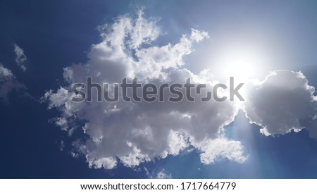 Sun beams or rays breaking through the white clouds. Hope, prayer, God's mercy and grace. Beautiful spectacular conceptual meditation background. Artistic sunset edit.