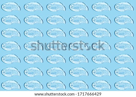 Group of transparent gel smears on blue background. Virus protection or cosmetics concept. Loopable elements. Royalty-Free Stock Photo #1717666429