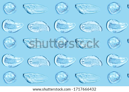 Group of transparent gel smears on blue background. Virus protection or cosmetics concept. Loopable elements. Royalty-Free Stock Photo #1717666432