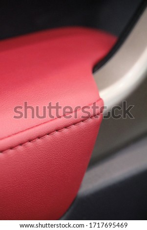 Red leather textures of the car interior design. Luxury materials. 