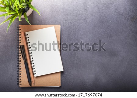 Office desk table with notebook and pen with pencil with copy space, top view