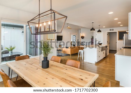 Beautiful Farm House Kitchen and Dining Space with Large Island  Royalty-Free Stock Photo #1717702300
