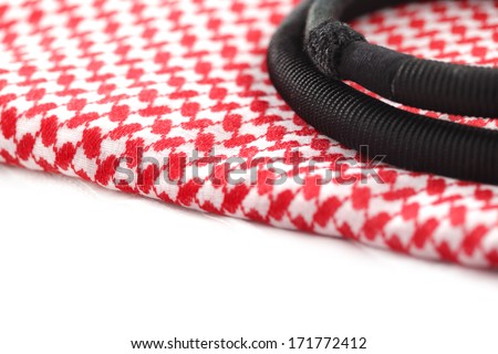 A close up image of a Ghutrah also known as the Keffiyeh along with the agal and skull cap. These items of clothing are usually worn by men as a head-dress in Arab Countries Royalty-Free Stock Photo #171772412