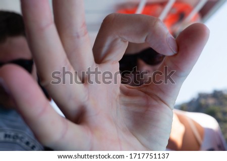 female hand shows okay sign with fingers