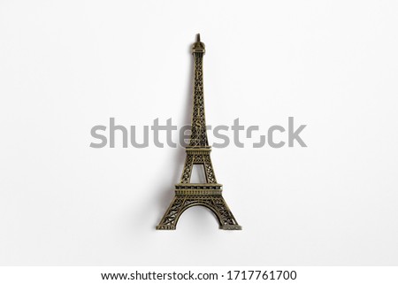 The small Eiffel tower as a souvenir from Paris. Isolated on a white background.