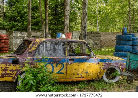 An old abandoned defeated police car in a remote forest