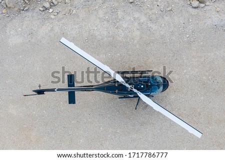 Aerial view of Black Helicopter on a desert ground  