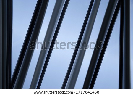 Reworked photo of office building exterior or interior fragment. Glass wall with aluminum or steel framework. Geometric structure of parallel lines. Abstract modern architecture background.