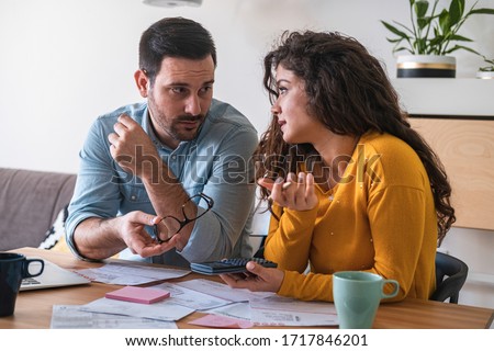 Young couple calculating finance at desk stock photo