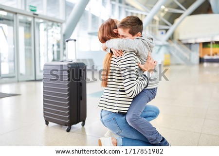 Son embraces his mother sincerely on reunion after a trip in the airport terminal Royalty-Free Stock Photo #1717851982