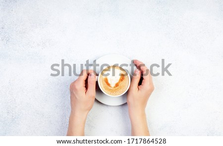 Hand holding one cup of coffee on white color background
