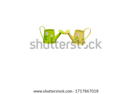 Two watering cans of yellow and green colors on a white background, gardening, space for text

