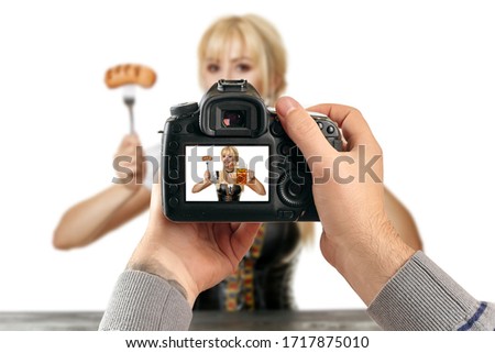 Digital single-lens reflex camera in hands. Man photographer makes photos. Male hands hold the camera close-up