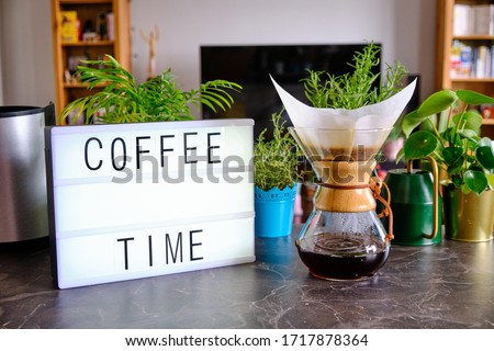 Lightbox written "Coffee Time". Home environment in the background. Concept for special brew coffee and making coffee at home.