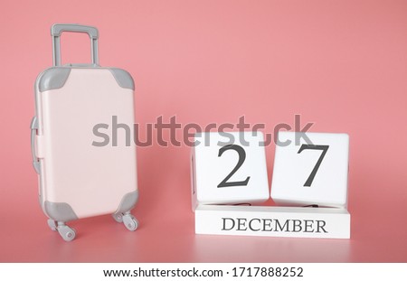 Calendar wooden cube. December 27, time for a winter holiday or travel, vacation calendar