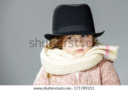 Distracted little girl portrait isolated on grey background