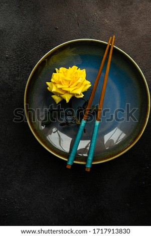 Table setting with yellow roses and cutlery on rustic table with copy space
