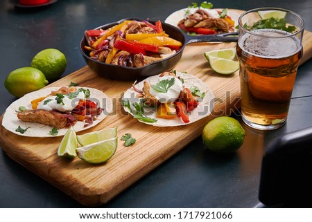 Mexican fajitas served on a wooden board on a table