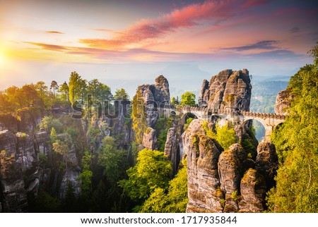 Elbe Sandstone Mountains in the evening light. Location Saxon Switzerland national park, Bastei bridge, East Germany, Europe. Photo of popular tourist attraction. Discover the beauty of earth. Royalty-Free Stock Photo #1717935844