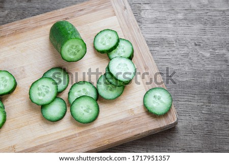 Top view slices of cucumber on a cutting board. Fresh summer food and healthy eating concept