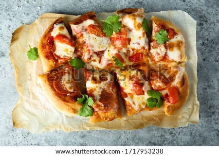 Homemade pizza with tomatoes and sausageS